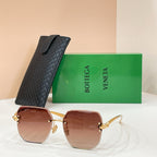Bottega Veneta sunglasses with gold-tone frame and reddish-brown tinted lenses