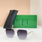Bottega Veneta sunglasses with gold-tone frame and dark purple tinted lenses