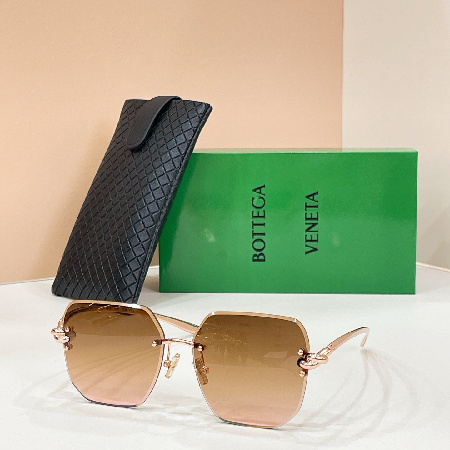 Bottega Veneta sunglasses with gold-tone frame and caramel tinted lenses