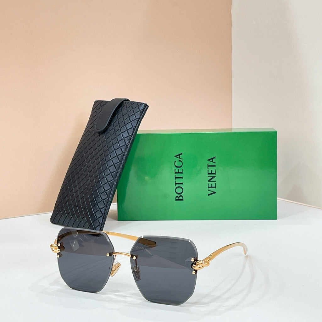 Bottega Veneta sunglasses with gold-tone frame and charcoal tinted lenses