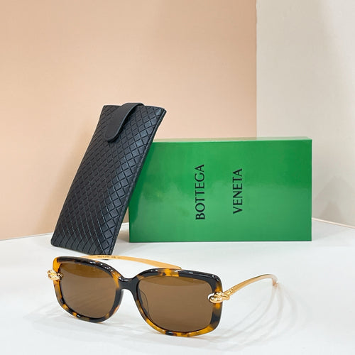 Square sunglasses with tortoise-brown frame and dark brown lenses, gold-tone details
