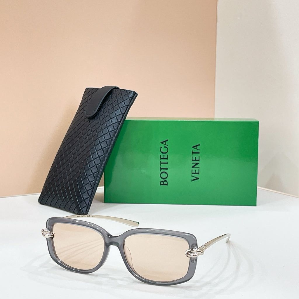 Square sunglasses with gray frame and beige-tinted lenses, gold-tone temple details