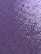 Purple T-shirt fabric close-up with dense textured graphic dots and pattern