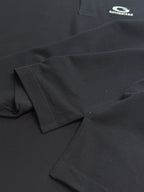 Balenciaga dark polo shirt fabric close-up, textured weave and stitched edge
