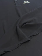 Balenciaga dark polo shirt fabric detail with stitched seam and drape
