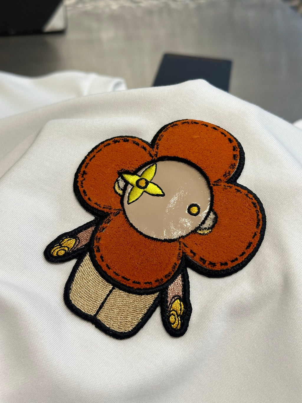 White T-shirt close-up of large colorful bear graphic on chest