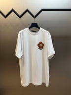 White T-shirt with colorful bear graphic on left chest, crew neck