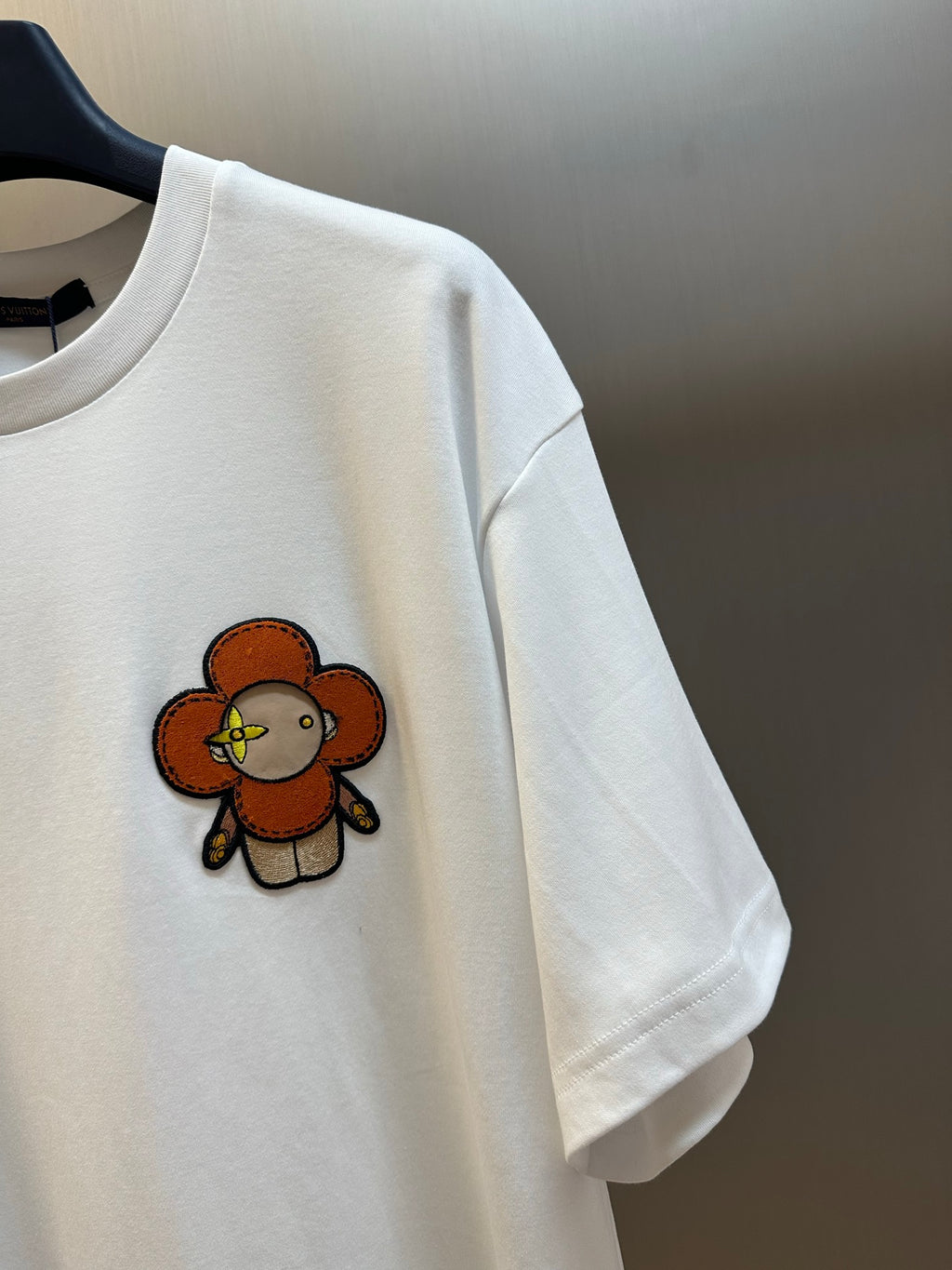 White T-shirt chest close-up of embroidered bear graphic