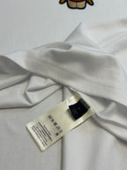 White T-shirt fabric close-up with size and care label near hem
