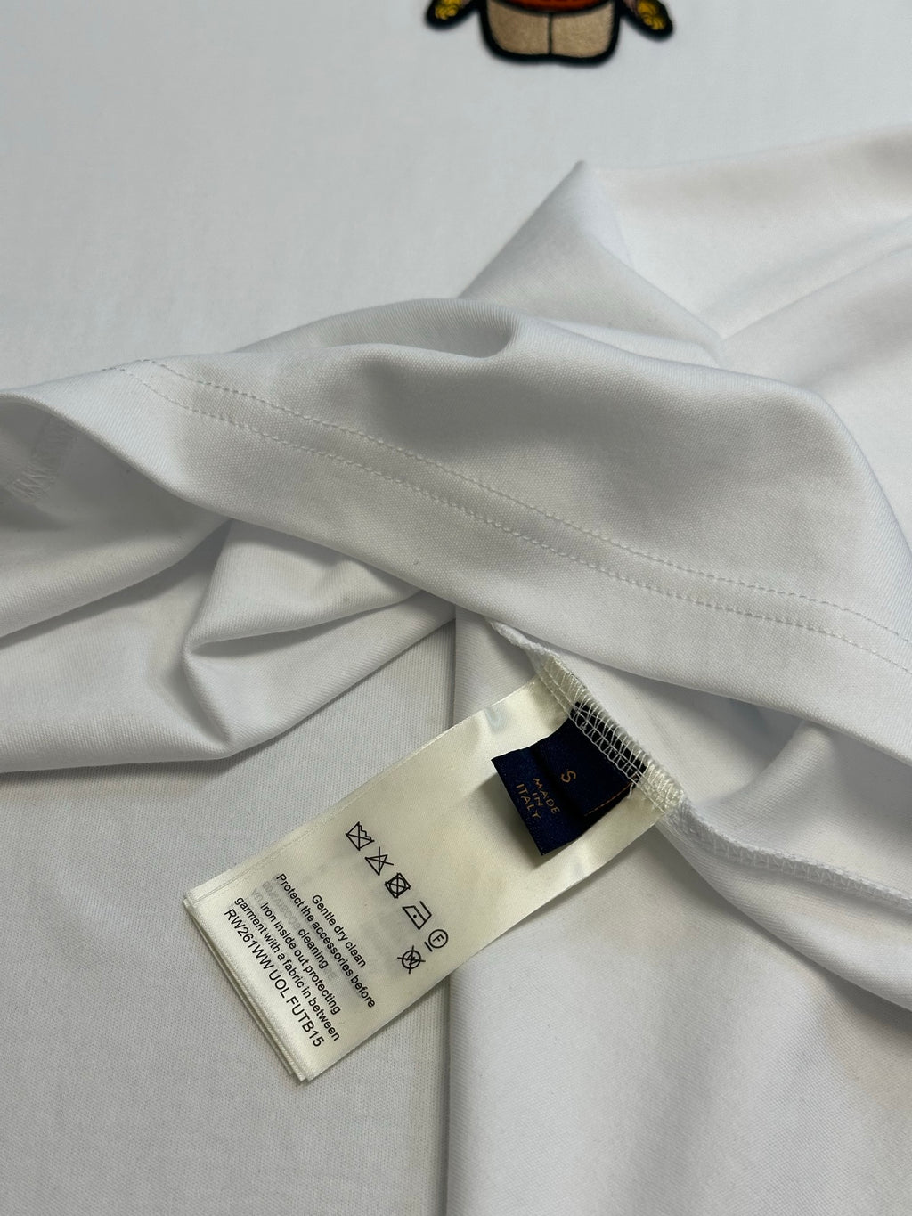 Louis Vuitton white T-shirt fabric with care labels near neckline