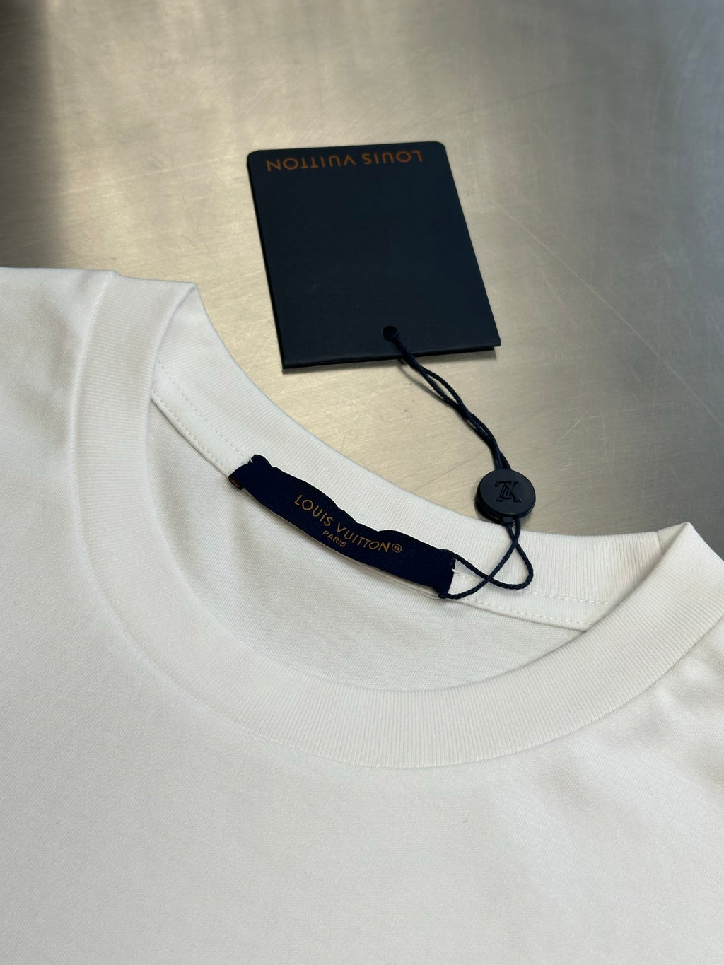 White T-shirt collar with cord tag and interior brand label