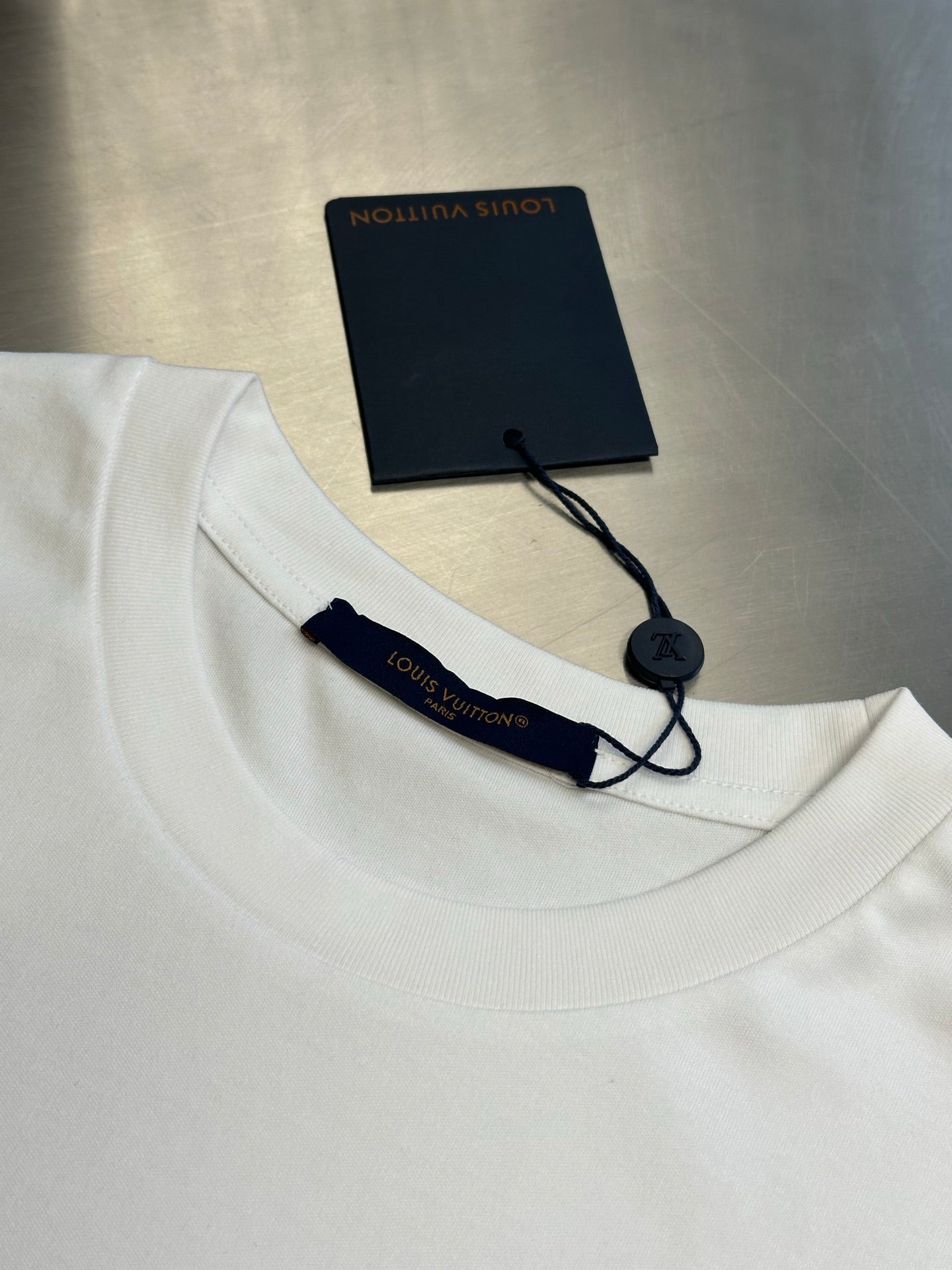 Louis Vuitton white T-shirt collar with navy brand tags and cord