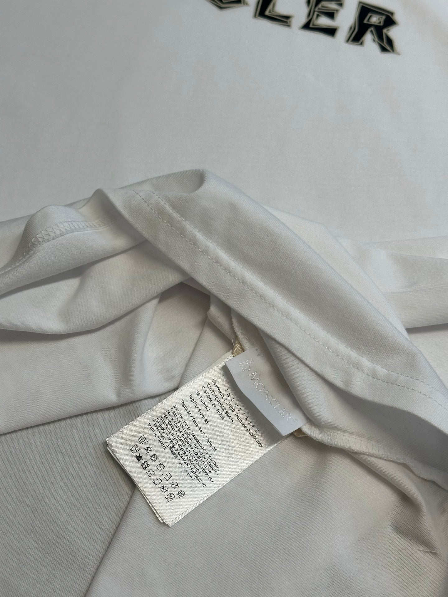 White T-shirt with care label inside at the collar seam