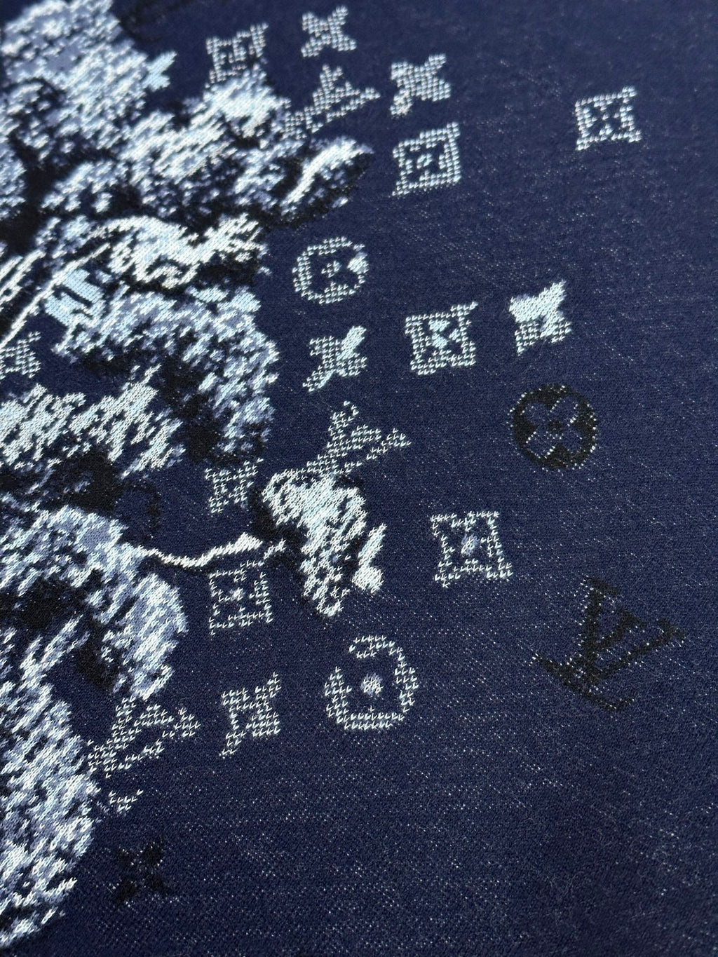 Navy knit T-shirt fabric close-up with white graphic pattern