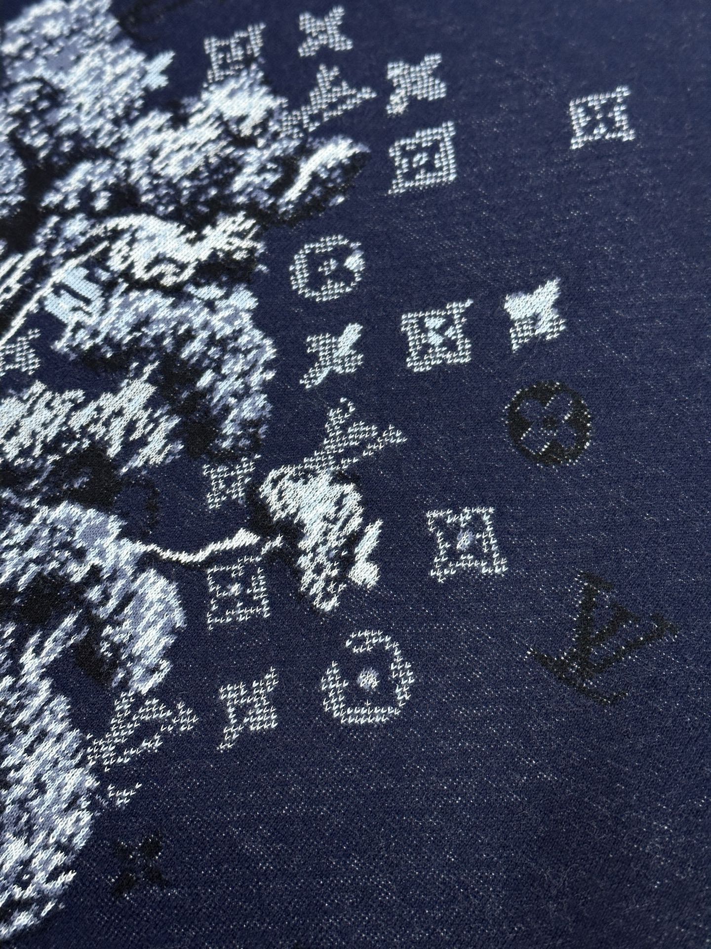 Navy knit T-shirt fabric close-up with white graphic pattern