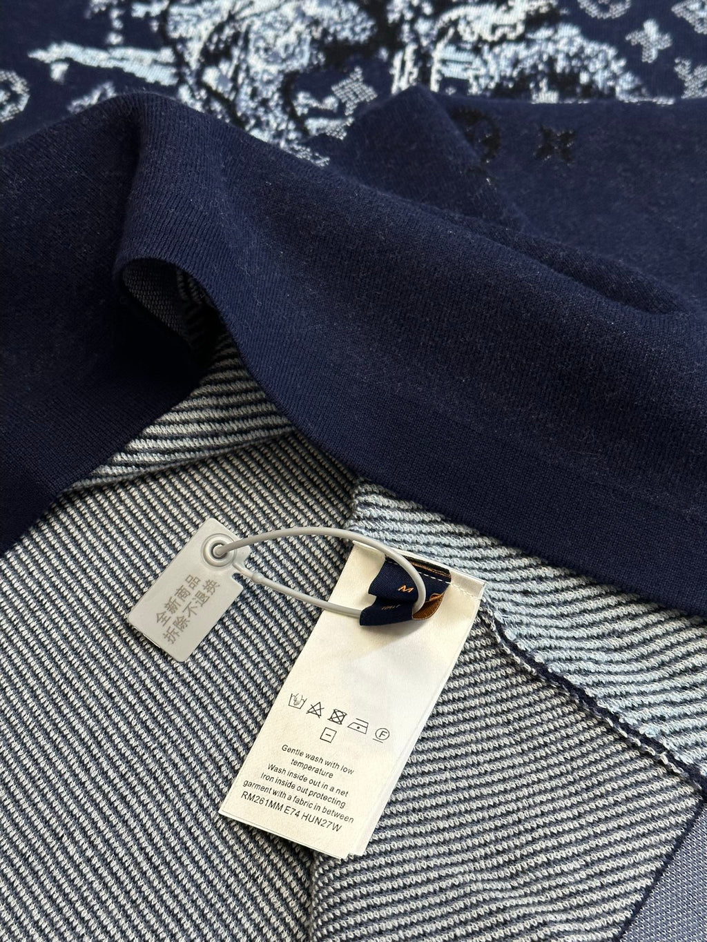 Navy T-shirt inside collar with woven tag and hanging label