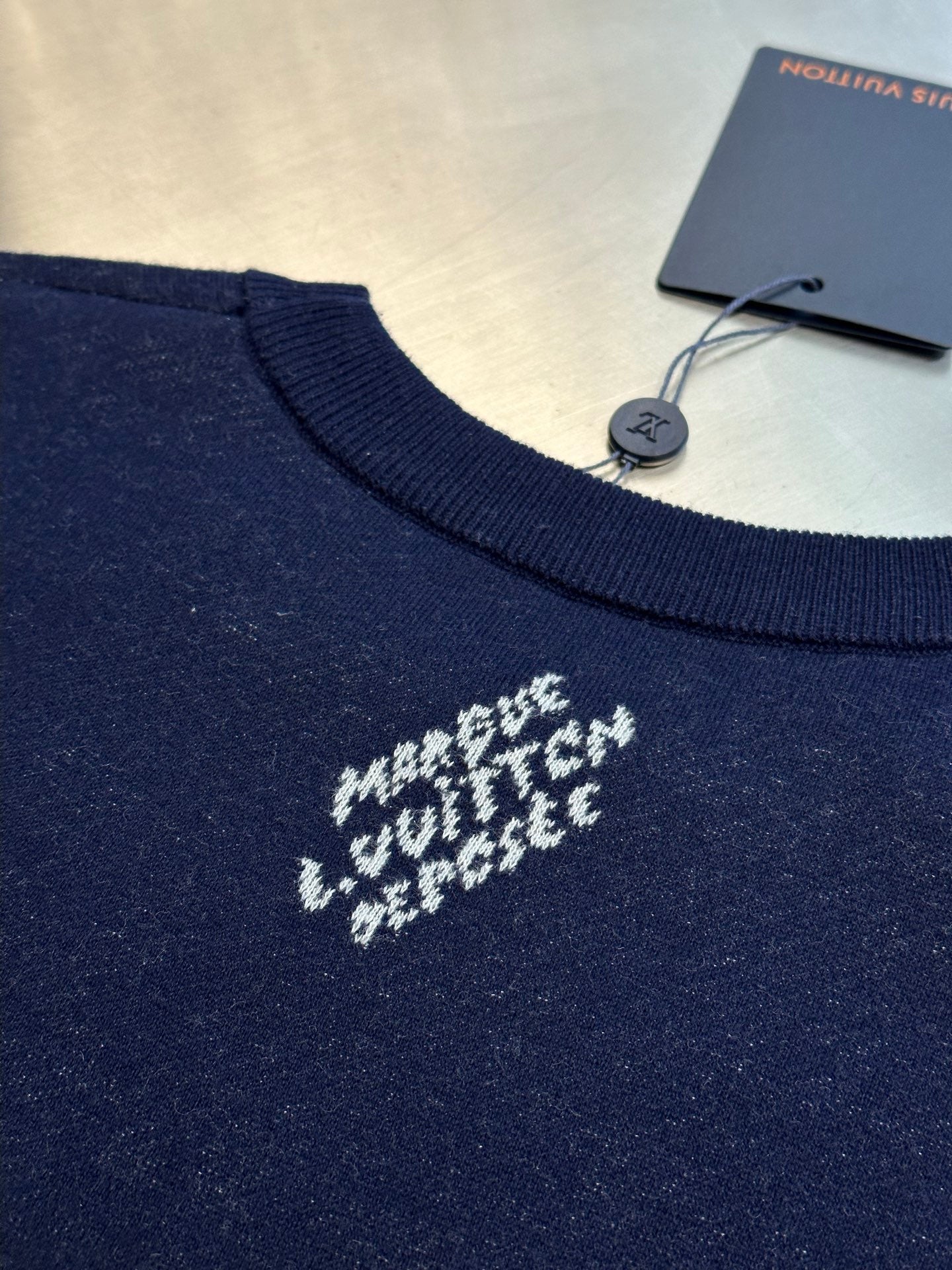 Navy T-shirt chest with small centered white motif