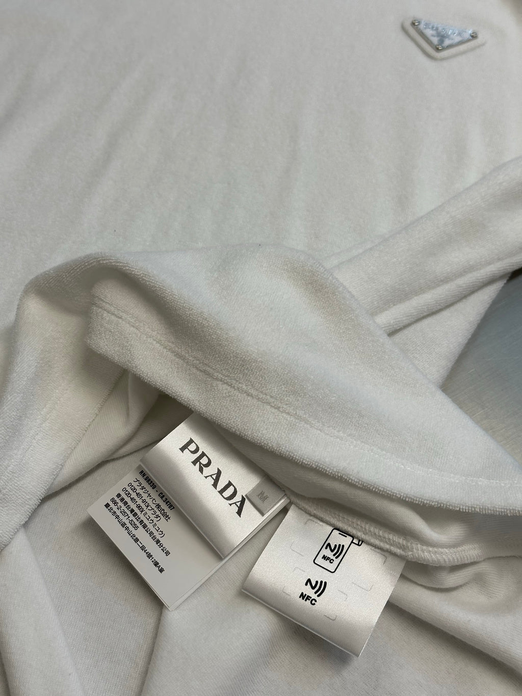 Prada T-shirt with care labels on folded white fabric