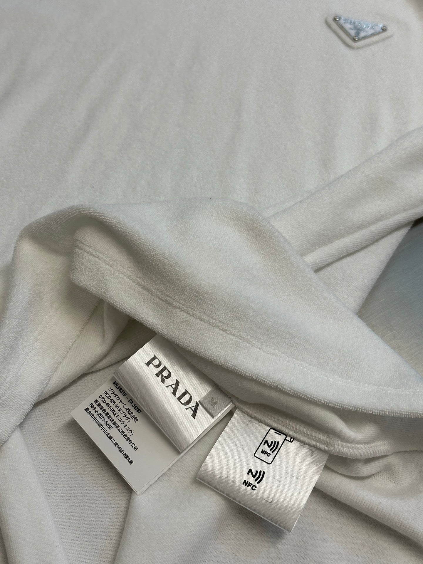 Prada T-shirt with care labels on folded white fabric