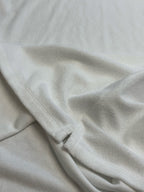 Prada white T-shirt fabric close-up with stitched side seam