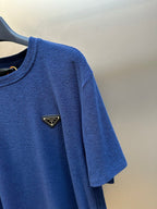 Blue short-sleeve T-shirt sleeve with small Prada triangle logo patch