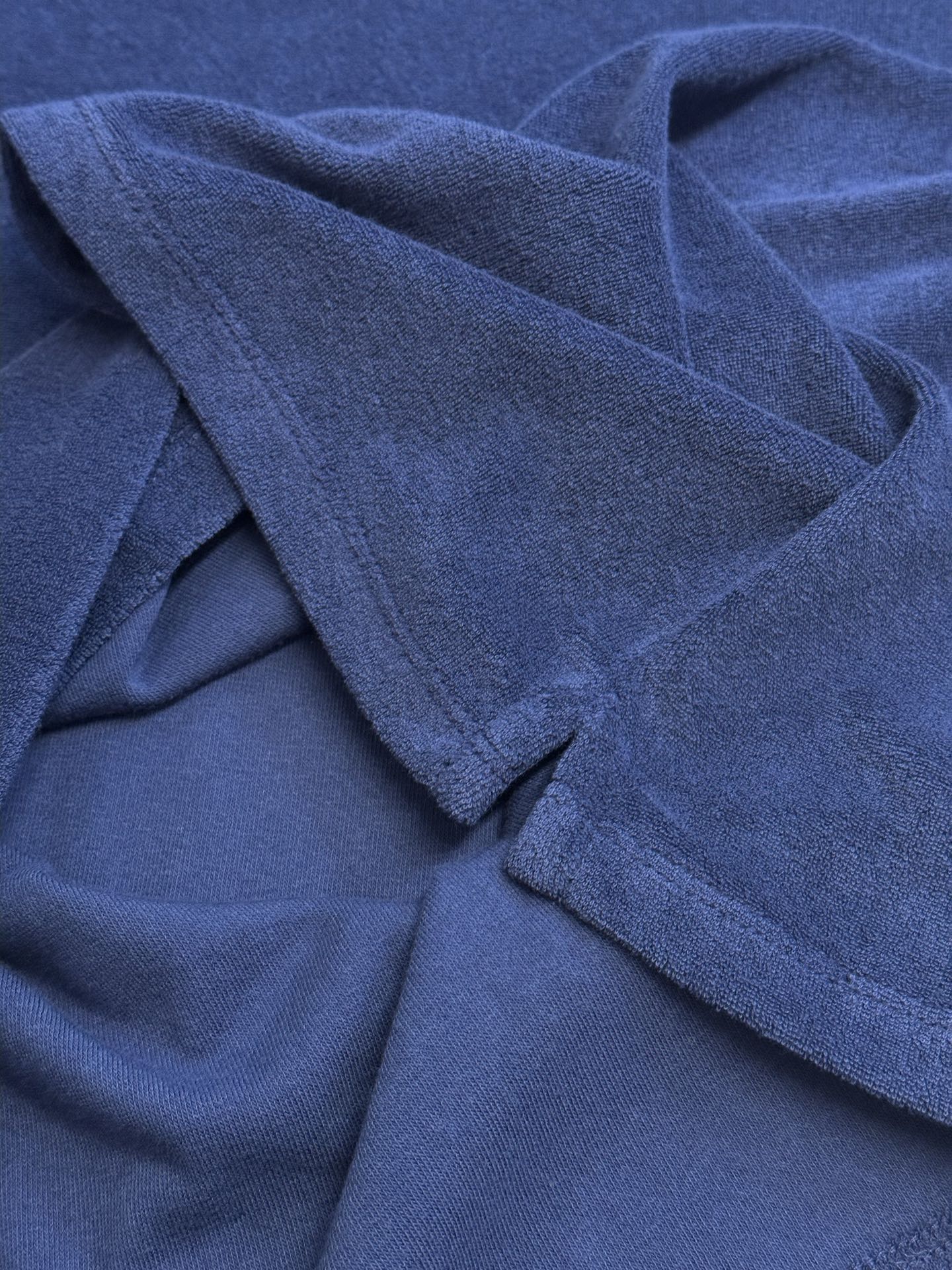 Blue short-sleeve T-shirt fabric drape with visible weave texture