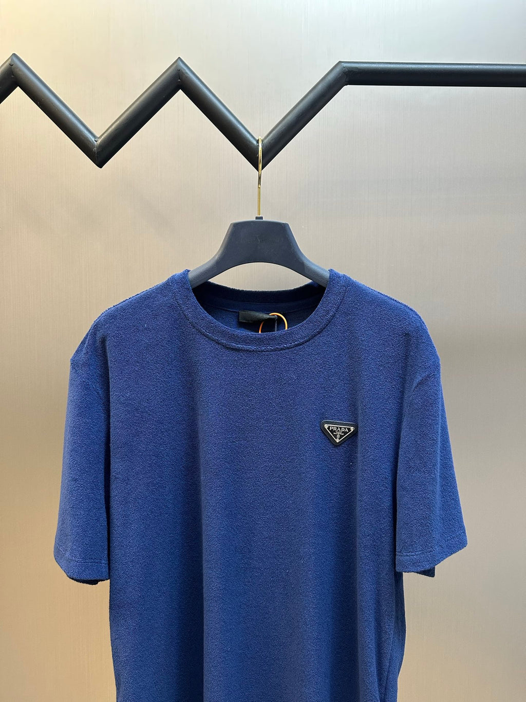 Prada short-sleeve T-shirt in blue, crew neck with triangular logo patch.