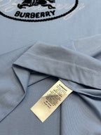 Light blue T-shirt shoulder seam with Burberry care label inside collar