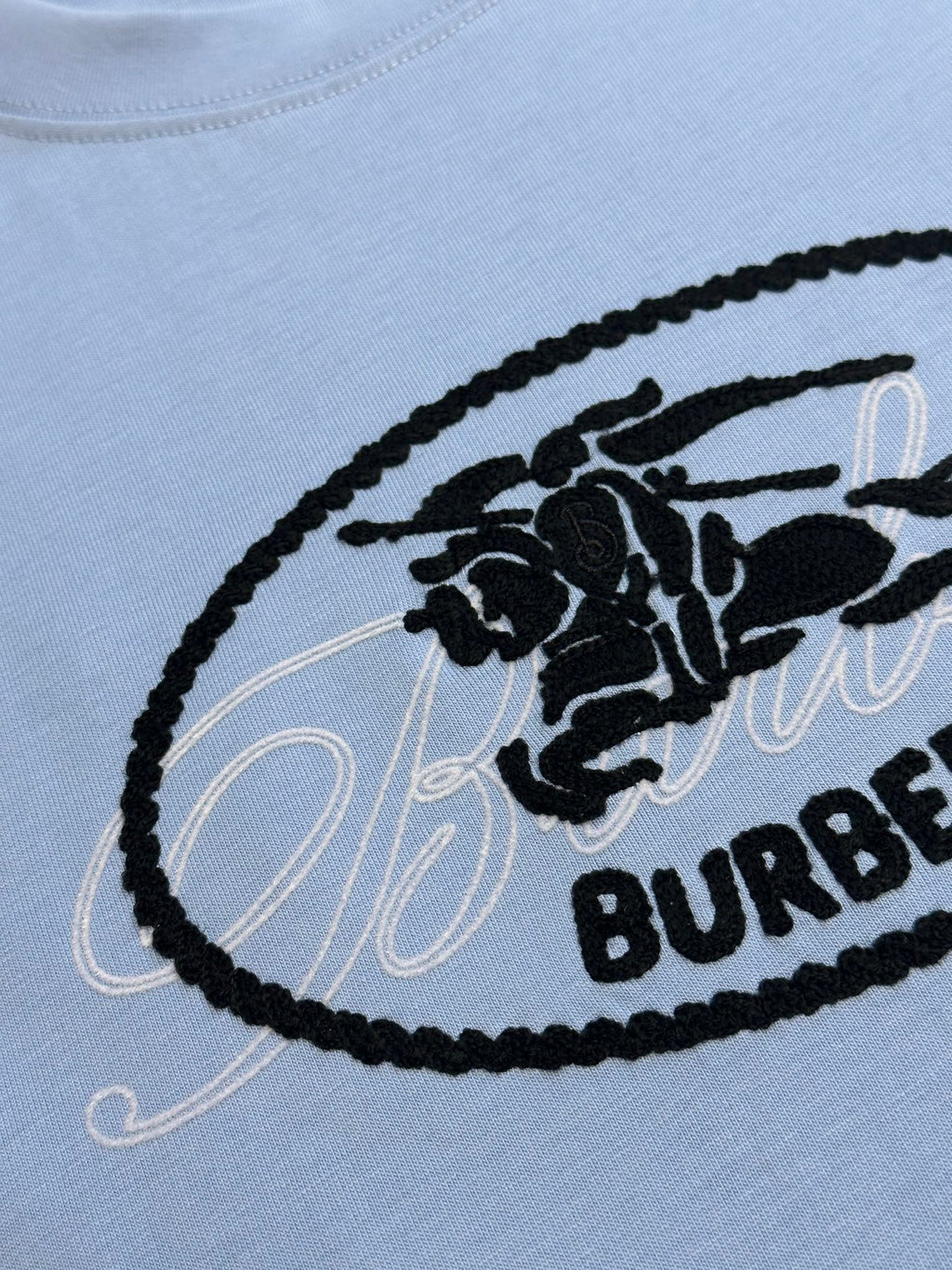 Light blue T-shirt with black oval Burberry logo embroidery