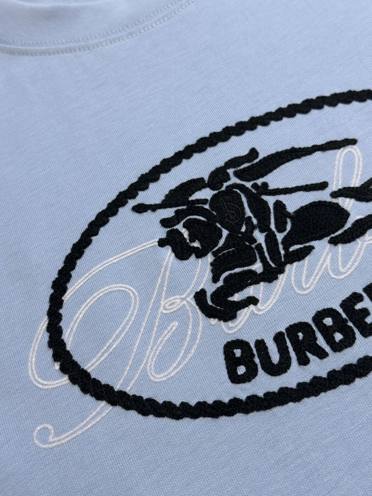 Light blue T-shirt with black oval Burberry logo embroidery