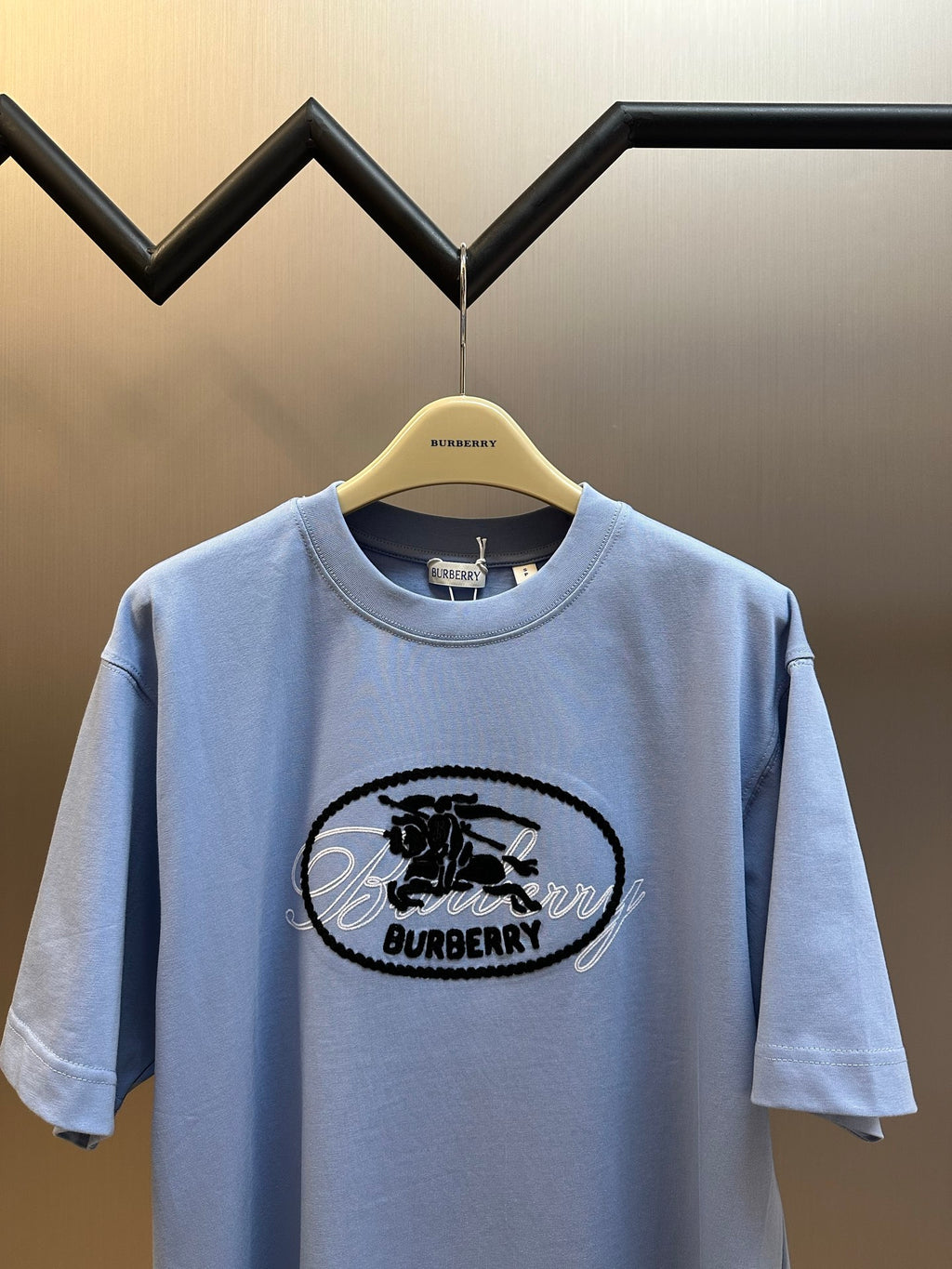 Light blue Burberry short-sleeve T-shirt front view with oval logo and crew neck