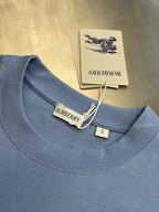 Light blue crewneck T-shirt collar with Burberry label and hanging tag