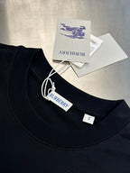 Black crew-neck T-shirt with inner label and size tag at collar