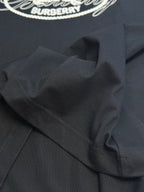 Black T-shirt shoulder seam and folded collar area