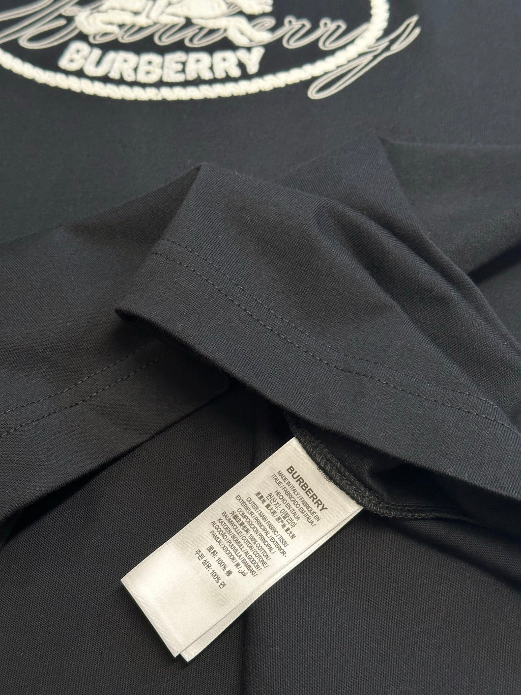 Black T-shirt sleeve and hem with care label
