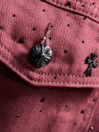 Maroon denim jacket pocket detail with dark round snaps and small stud pattern