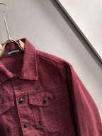 Maroon denim jacket close-up on hanger, point collar, snap front, small stud accents