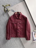 Maroon long-sleeve denim jacket on hanger, point collar, snap buttons, chest and pocket seams