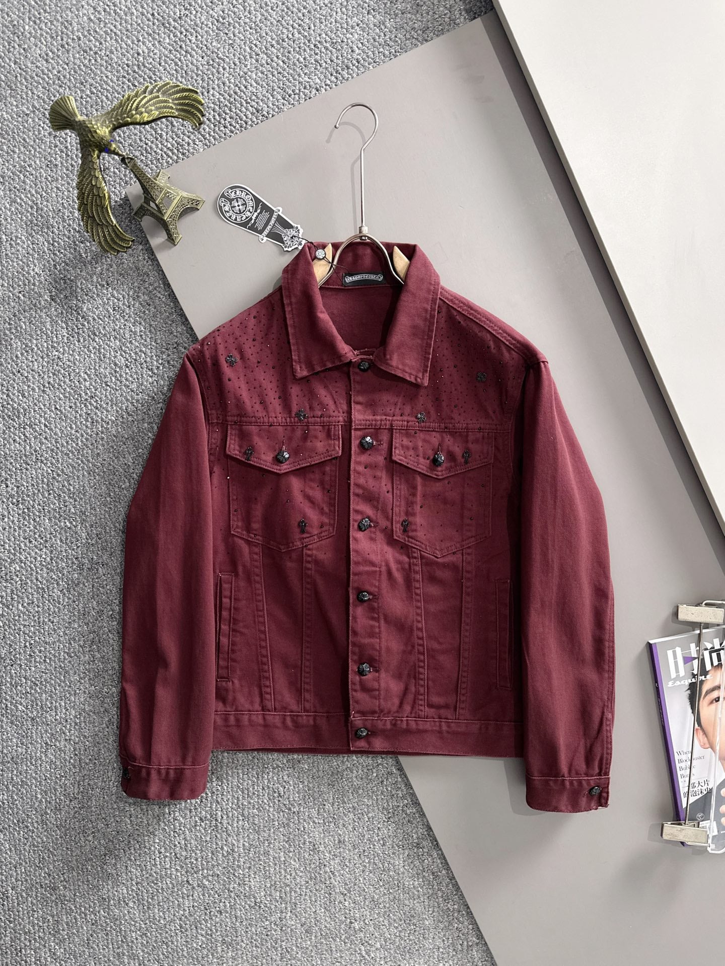 Maroon long-sleeve denim jacket on hanger, point collar, snap buttons, chest and pocket seams