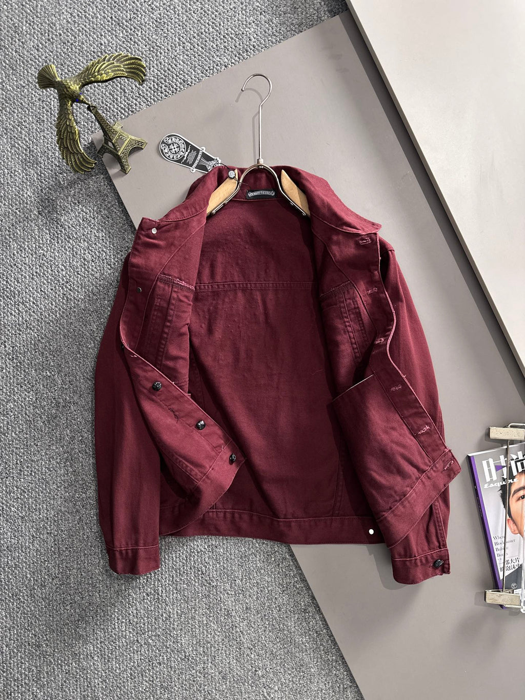 Maroon long-sleeve denim jacket front on hanger, point collar, snap buttons, stud accents