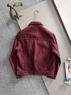 Maroon denim jacket back on hanger, long sleeves, snap buttons, studded texture