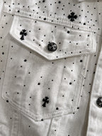 White denim jacket front with black dot pattern, star appliques, and round decorative button