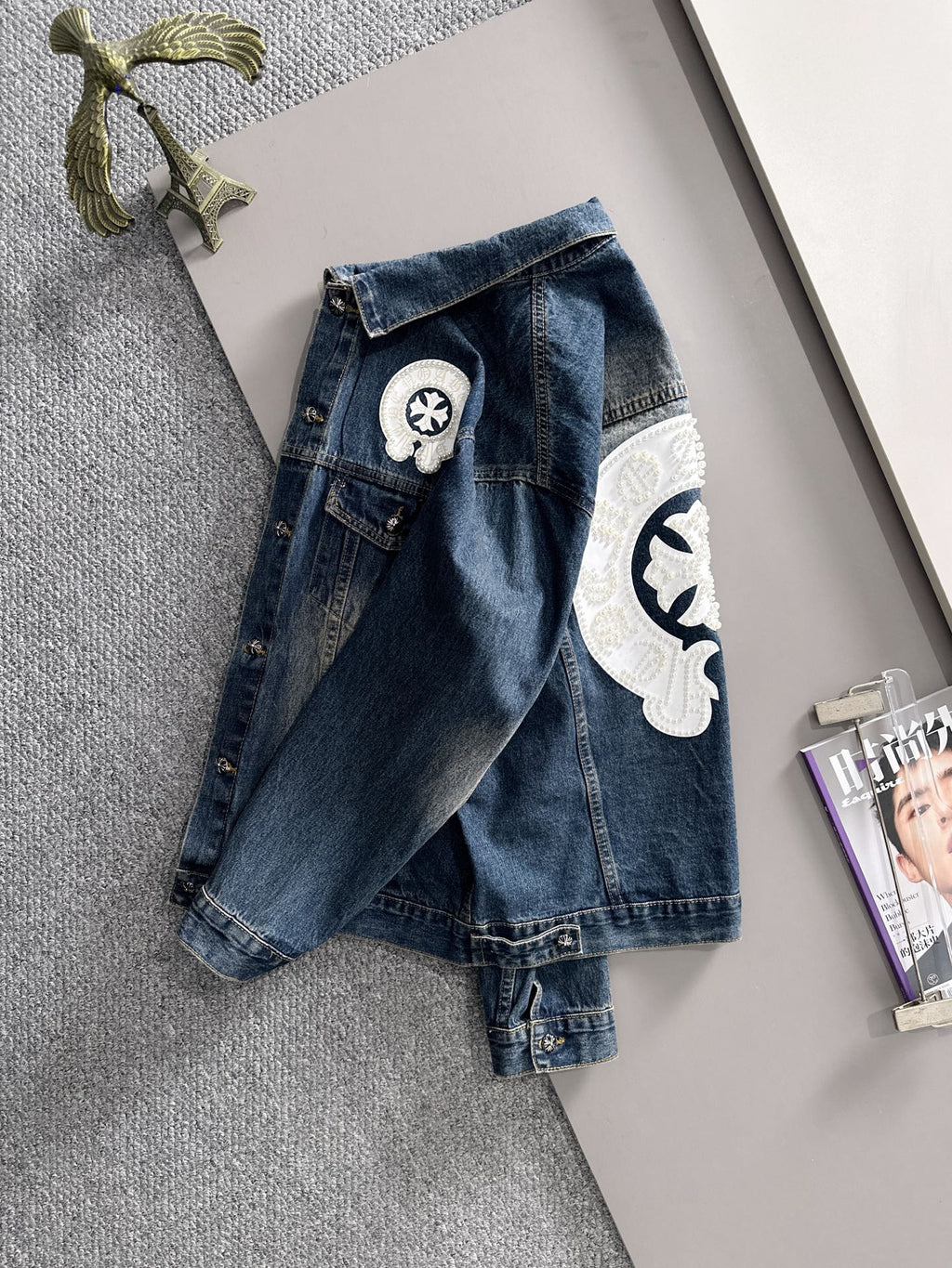 Blue long denim jacket back view with white pearl emblem and chest patch