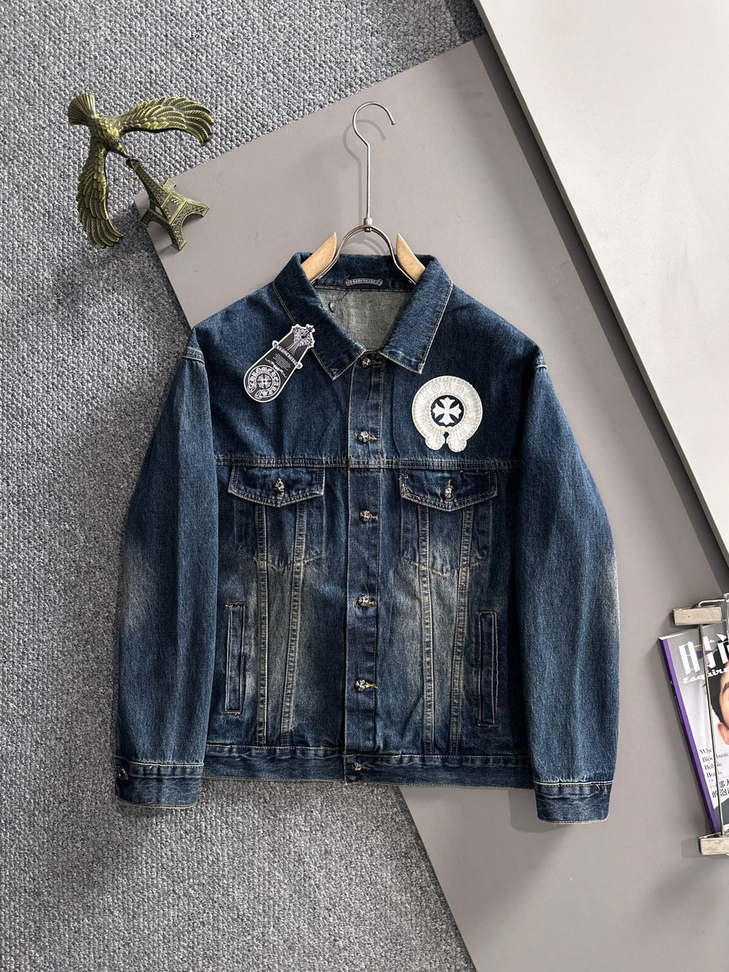 Blue long denim jacket with pearl button patches and decorative lapel emblems