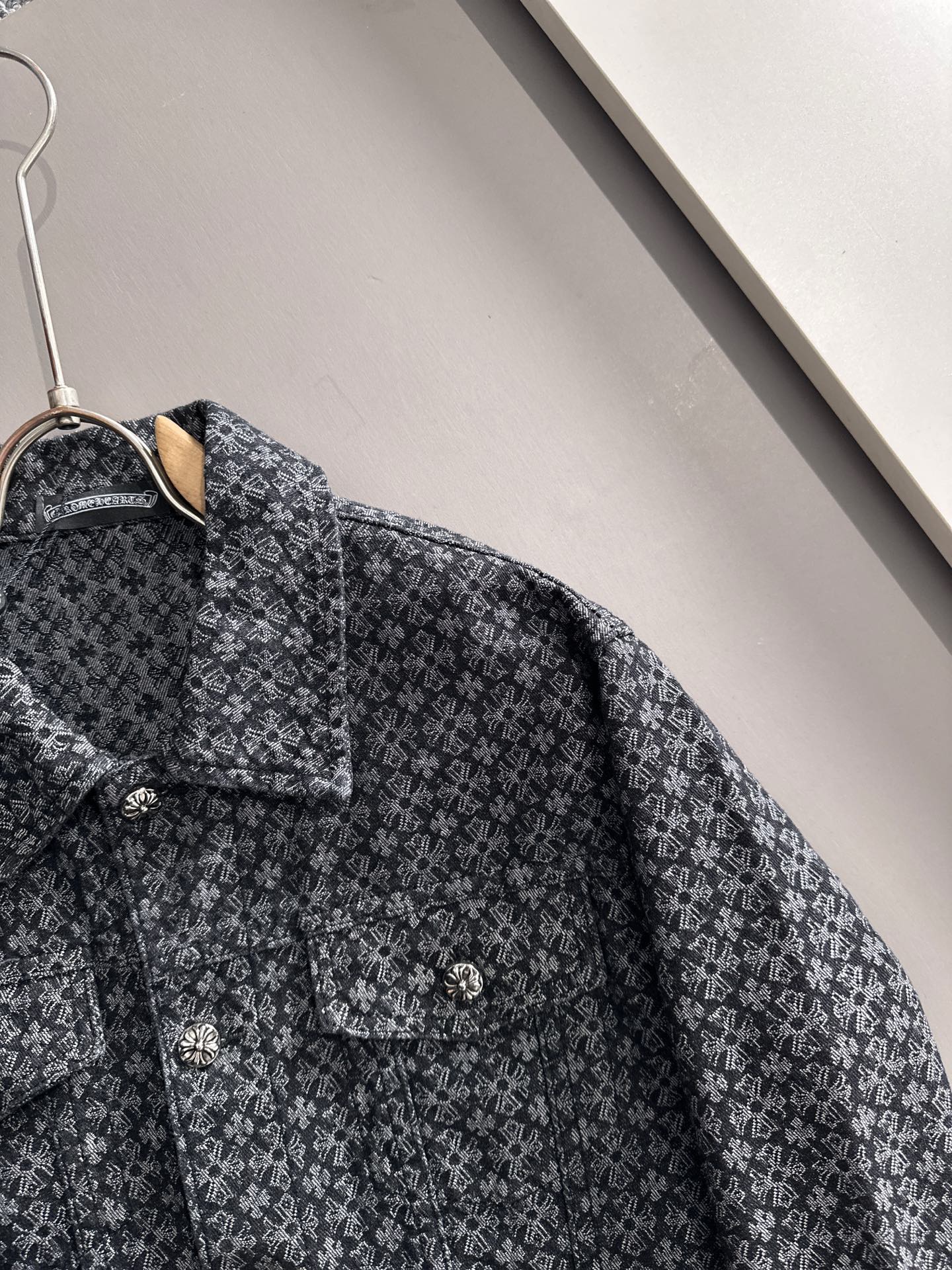 Patterned long-sleeve jacket shoulder and chest detail with button front