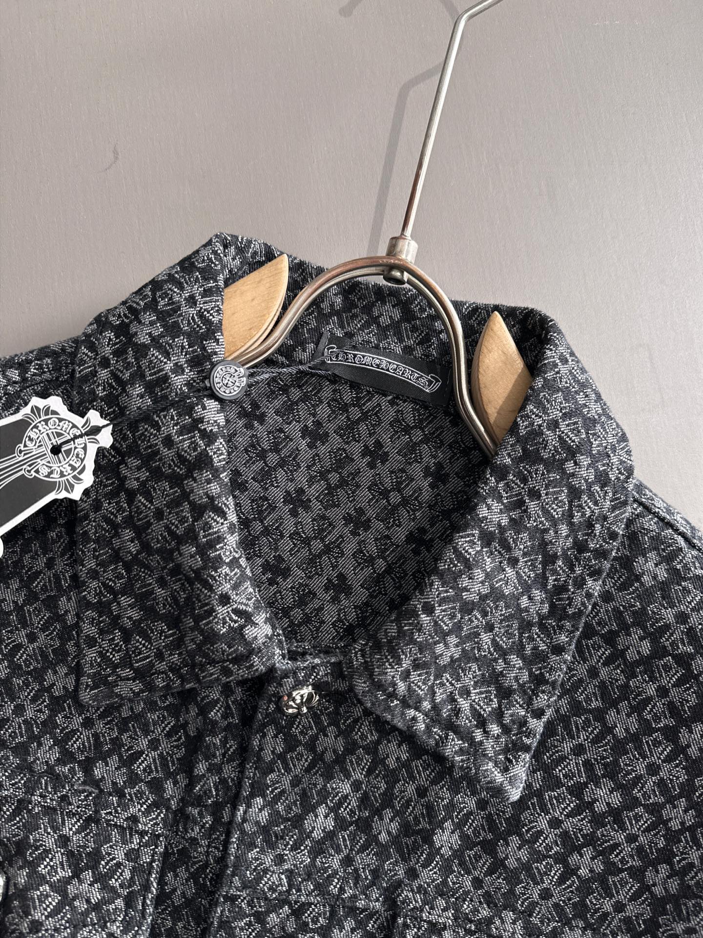 Patterned long-sleeve jacket on hanger, showing pointed collar and chest pockets
