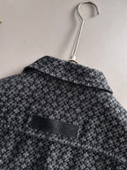 Back of patterned long-sleeve jacket on hanger with wide collar