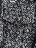 Close-up of jacket chest flap and round button on patterned fabric