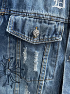 Blue denim jacket chest pocket with small flower emblem and stitched detailing