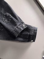 Dark denim jacket sleeve cuff with button and embroidered patch accents